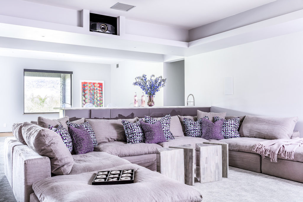 A home theatre in a smart ski house in Vermont equipped with blackout blinds installed by AW Treatments.